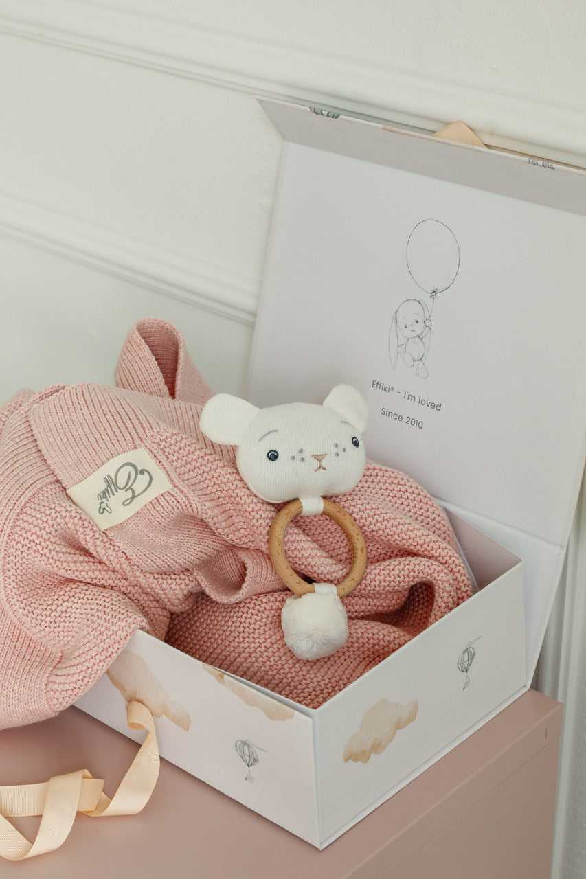 Foldable baby gift box open, displaying newborn items